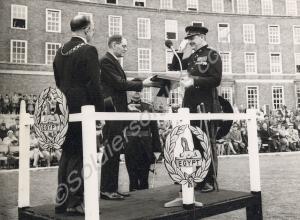 Reverend L. Ash Parsons presenting the Victoria Cr