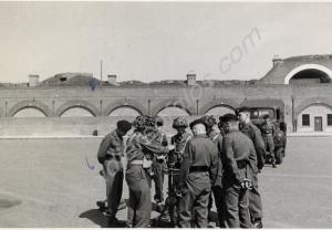 Major Harvey demonstrating 3" mortar.  Gloucesters
