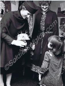 The Duchess of Gloucester being presented with a b
