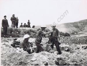 3" mortar training. Lieutenant T.D. Cooper looks o