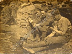 Three soldiers sitting in a trench, Private Hubert