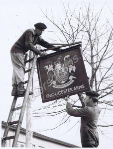 Raising the pub sign for the Corporals' Club, "The