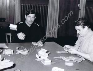 Captain W.G.R. Mirehouse destroying old money. Glo