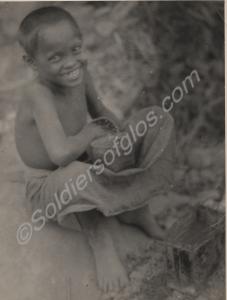 Small boy holding a basket. Burma. 1944-1945.