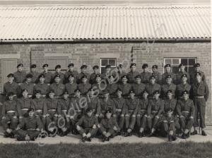 Lieutenant Claud Rebbeck with platoon outside barr