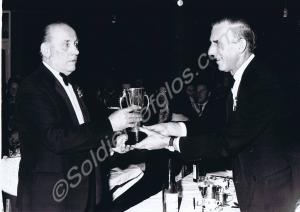 Mr. Charlie Smith, M.M., receiving the Cup for Bes