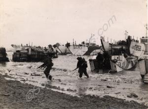 Soldiers going ashore from landing craft on the be