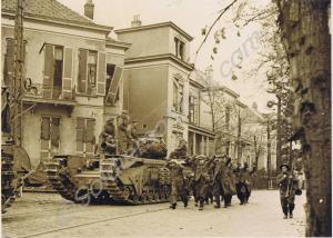 Churchill AVRE tank with German P.O.W.s walking pa