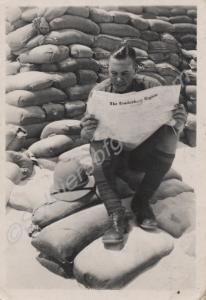 Soldier in tropical kit reading the Tewkesbury Reg