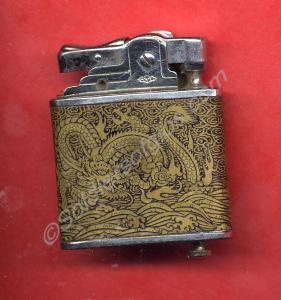 Black cigarette lighter with brass inlay. Chinese