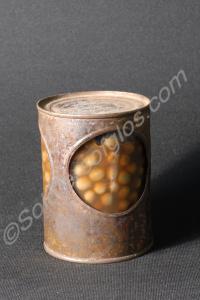 Peas in glass jar in tin cover with three large ho