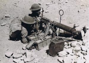 Two soldiers wearing gas masks with Vickers machin