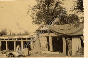 Soldiers in sandbagged wooden shelter. "Daily scen