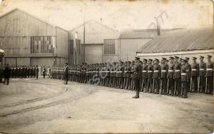 Standing to attention with naval personnel. 1st Ba