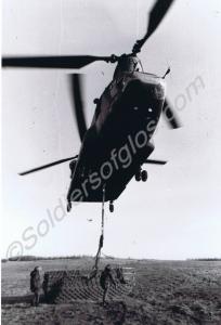 Chinook helicopter lifting assault boats.  Quarter