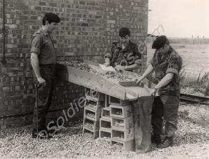 Captain Geoff England supervises the scrutiny of e