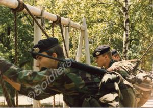 Soldiers tackling an assault course. 1st Battalion