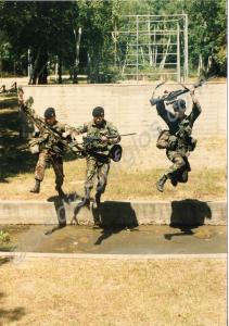 Soldiers tackling an assault course. 1st Battalion