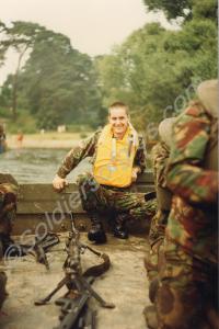 Soldiers on an assault pontoon barge crossing a bo