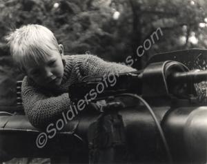Young boy inspecting weapon. Gloucestershire Regim