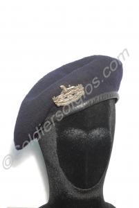 Blue beret with white metal front badge and brass