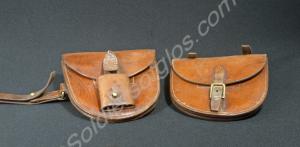 Two brown leather saddle pouches. (a) left pouch w