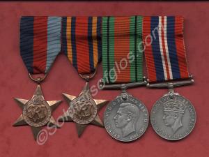Four medals with ribbons on holder. 1939-1945 Star