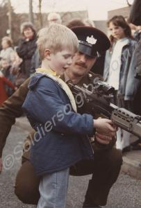 Soldier with small boy and rifle. Battalion Open D