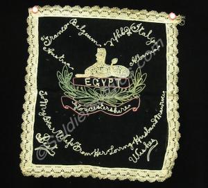 Embroidered and laced black velvet textile showing