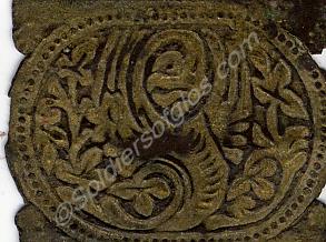 Piece of engraved metalwork, about an inch square,