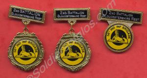 Three identical badges on two different mounts bel