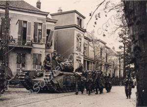 Churchill AVRE tank with German P.O.W.s walking pa