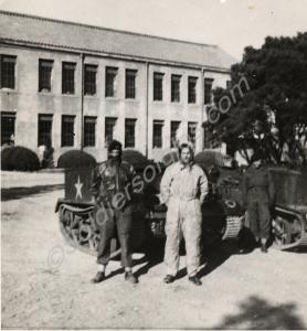 Three soldiers with two Universal Carriers. Corpor