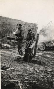 Lt.Colonel Carne with a mug standing by a field co