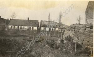 Sandbags, cemetery and damaged village. 1st Battal