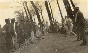 Soldiers on a road preparing for a bath. 1st Batta