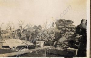 Soldiers in a sandbagged and damaged building. 1st