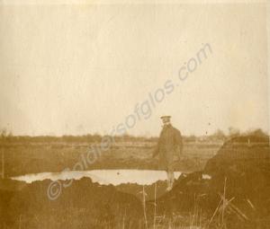 Shell hole with Jevons standing next to it. 1st Ba