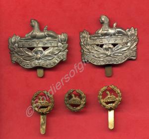 Two front and three back cap badges. William Regin