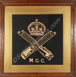 Framed embroidery of the Machine Gun Corps badge.
