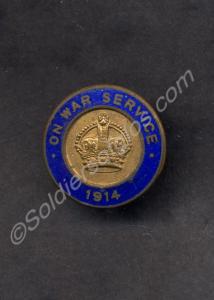 Brass and blue enamel  lapel badge. "ON WAR SERVIC