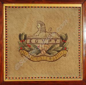 Framed embroidered cloth depicting  the front badg