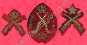 Three gold embroidered musketry badges, worn on sl