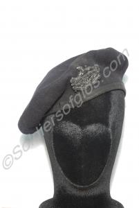 Blue beret with white metal front and back badges.