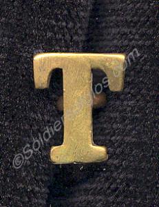 Brass letter "T" worn above brass "Gloster" should