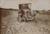 Car driving along a dirt road. India c. 1918.