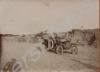 Car driving along a dirt road. India c. 1918.