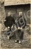 Two sergeants sitting on boxes by a tree.  1/4th B