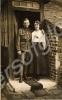 Soldier standing by porch with his wife . c. 1914-