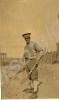 Soldier with goggles, rolled up trousers and spade